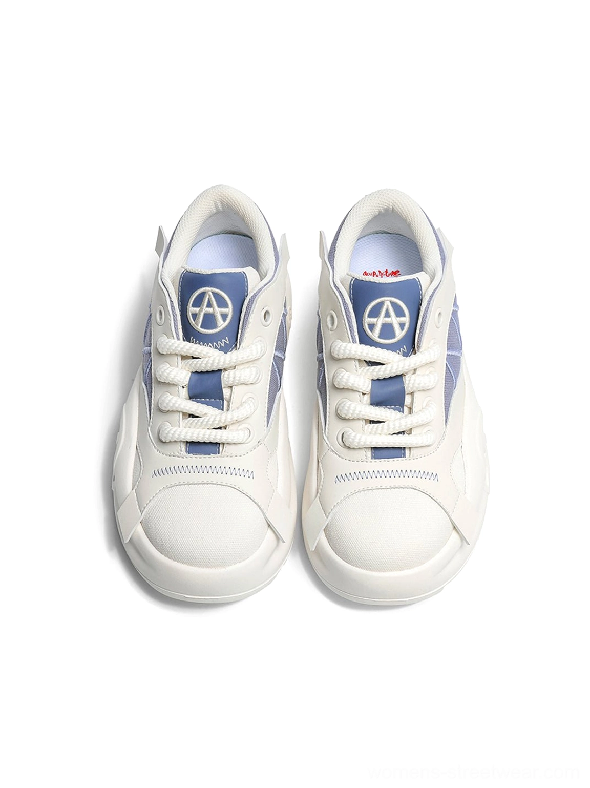 Front view of a pair of blue and cream geometric panel platform runner sneakers on a white background, showing the laces and blue lining