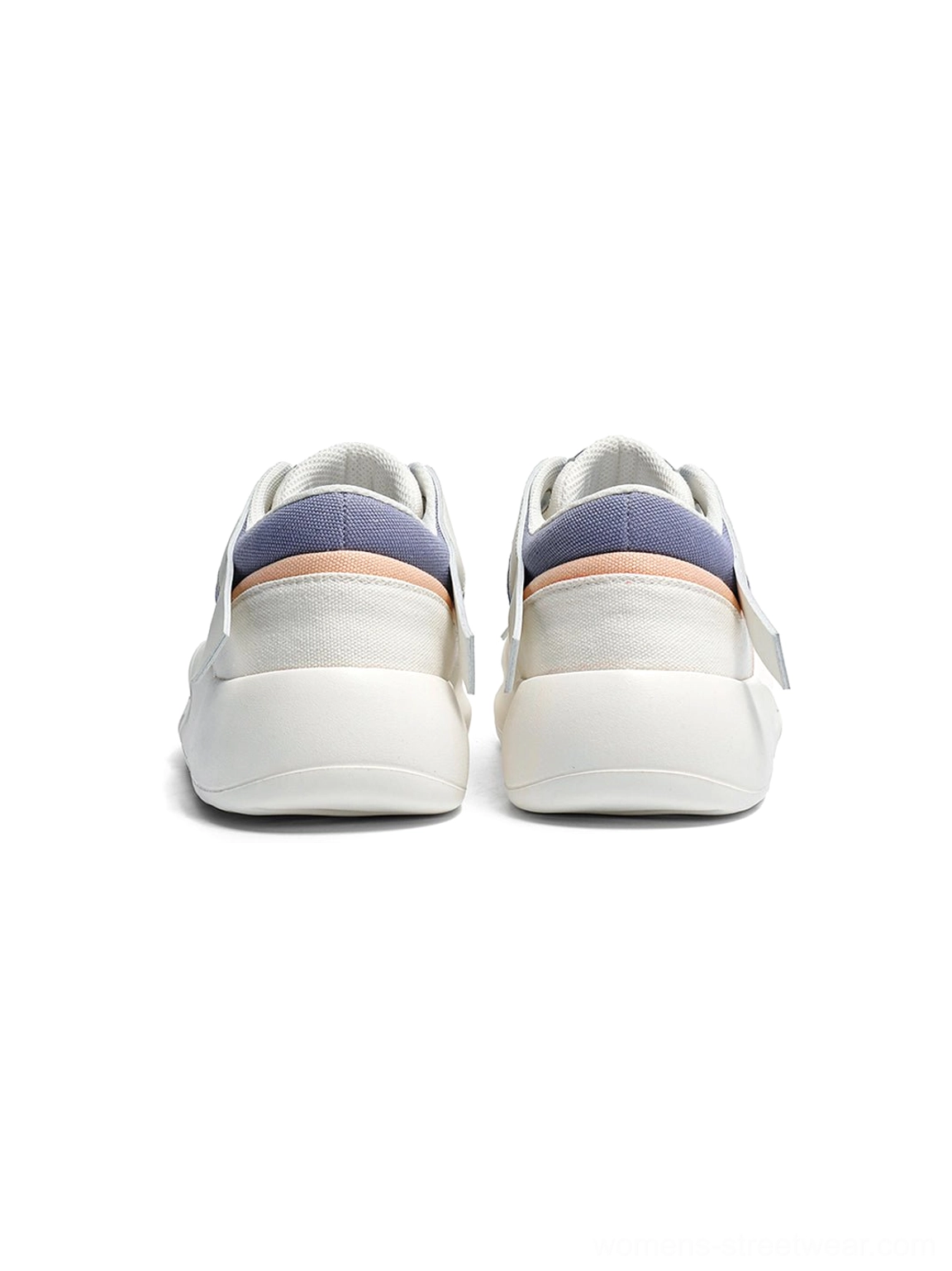 Rear view of a pair of geometric panel platform runner sneakers on a white background, showing color-blocked blue and peach heel tabs