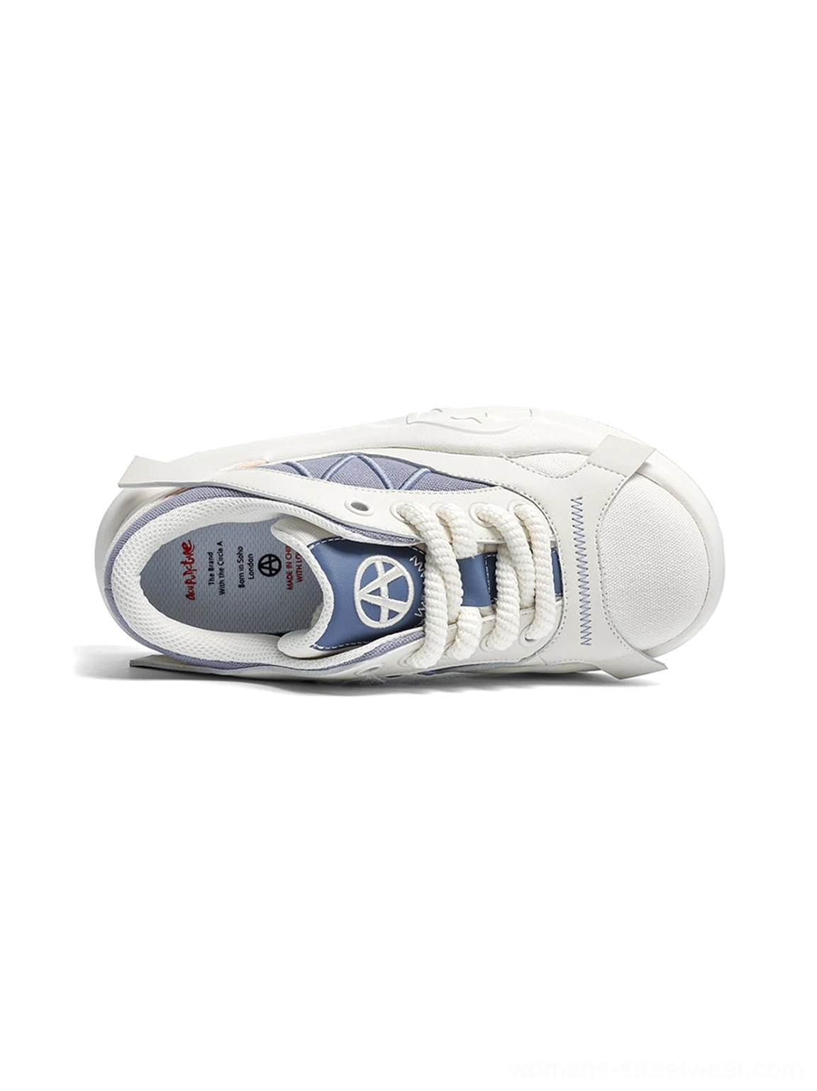 Top-down view of a single geometric panel platform runner sneaker on a white background, showing the laces, eyelets, and blue tongue panel