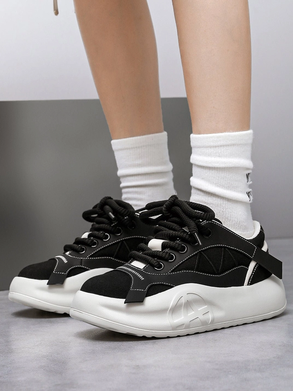 Additional gallery image of the geometric panel platform runner sneakers and their low-top, paneled silhouette