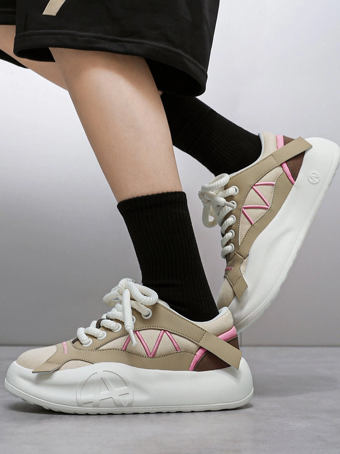 Gallery image featuring the low platform profile of the geometric panel runner sneakers