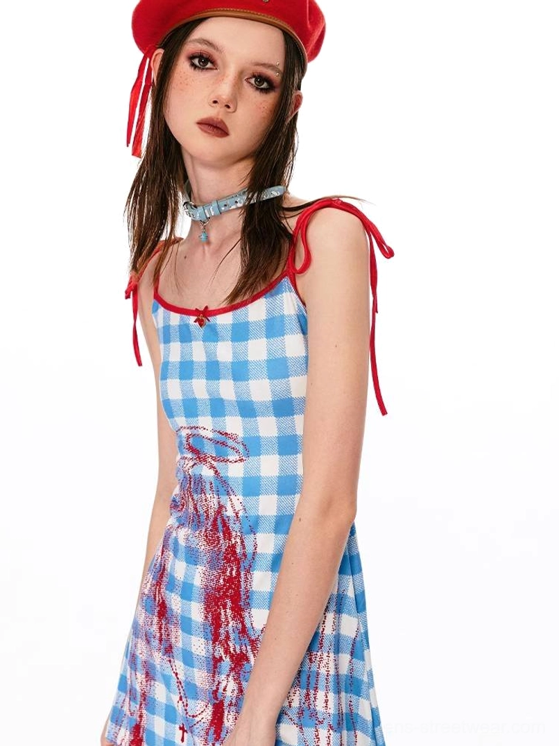 Gingham angel graphic cami mini dress styled with red tie shoulder straps, red trim, and matching red beret