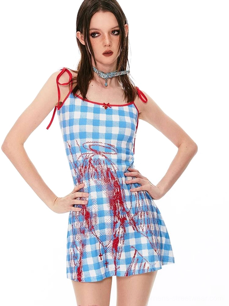 Blue and white gingham angel graphic cami mini dress with red tie straps and red bow detail shown from a front three-quarter view