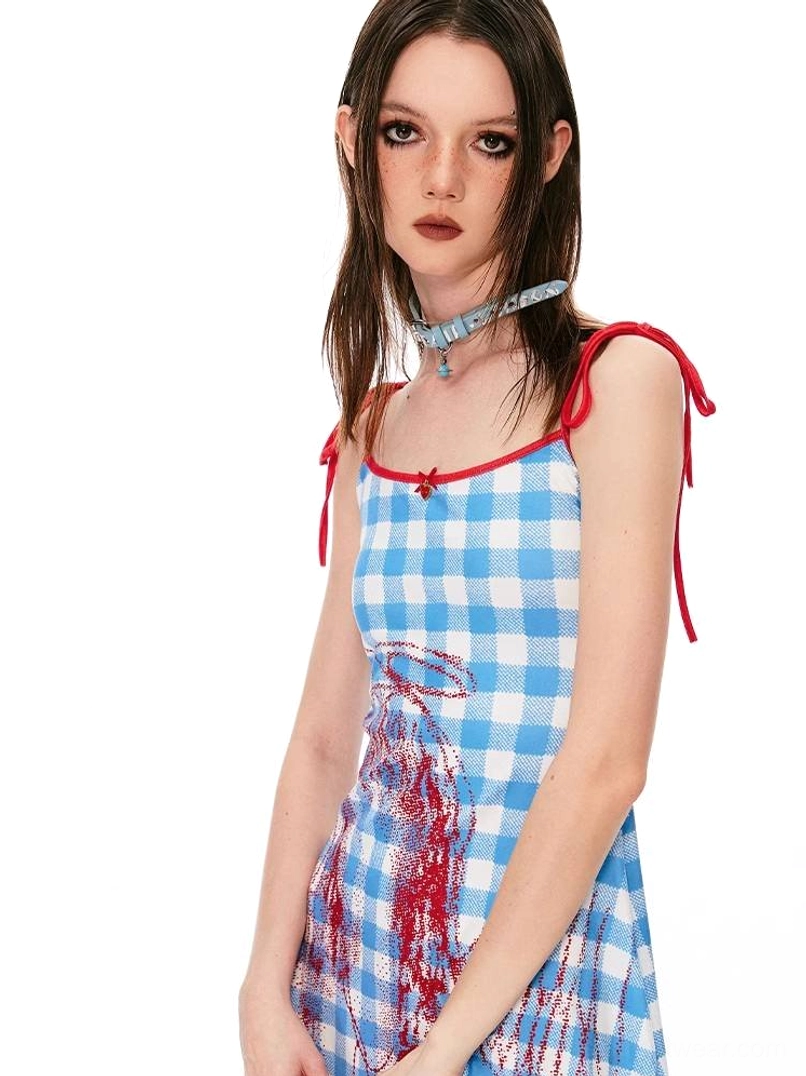 Side three-quarter view of gingham angel mini dress featuring red tie straps, front bow, and halo graphic detail