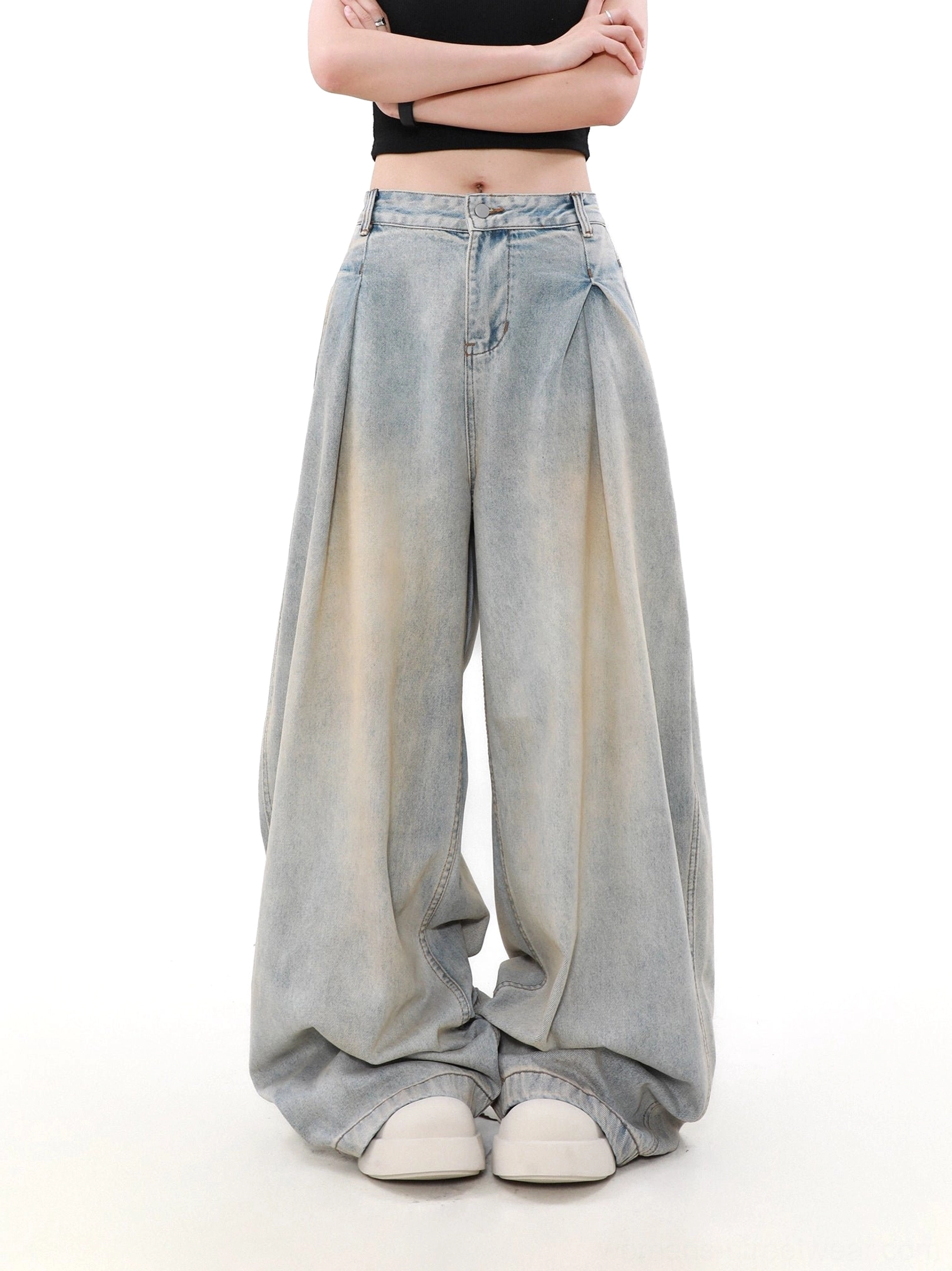 Straight front view of high-waisted women’s wide-leg denim jeans with deep pleats, vintage faded blue wash, and oversized streetwear silhouette