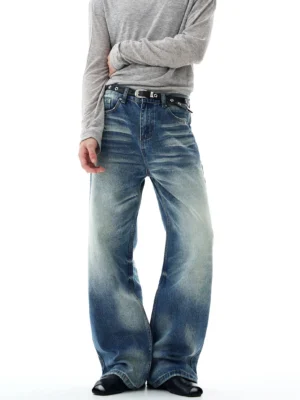 Full front view of retro blue glacier fade wide-leg flare jeans styled with a gray long-sleeve top, grommet belt, and black leather shoes