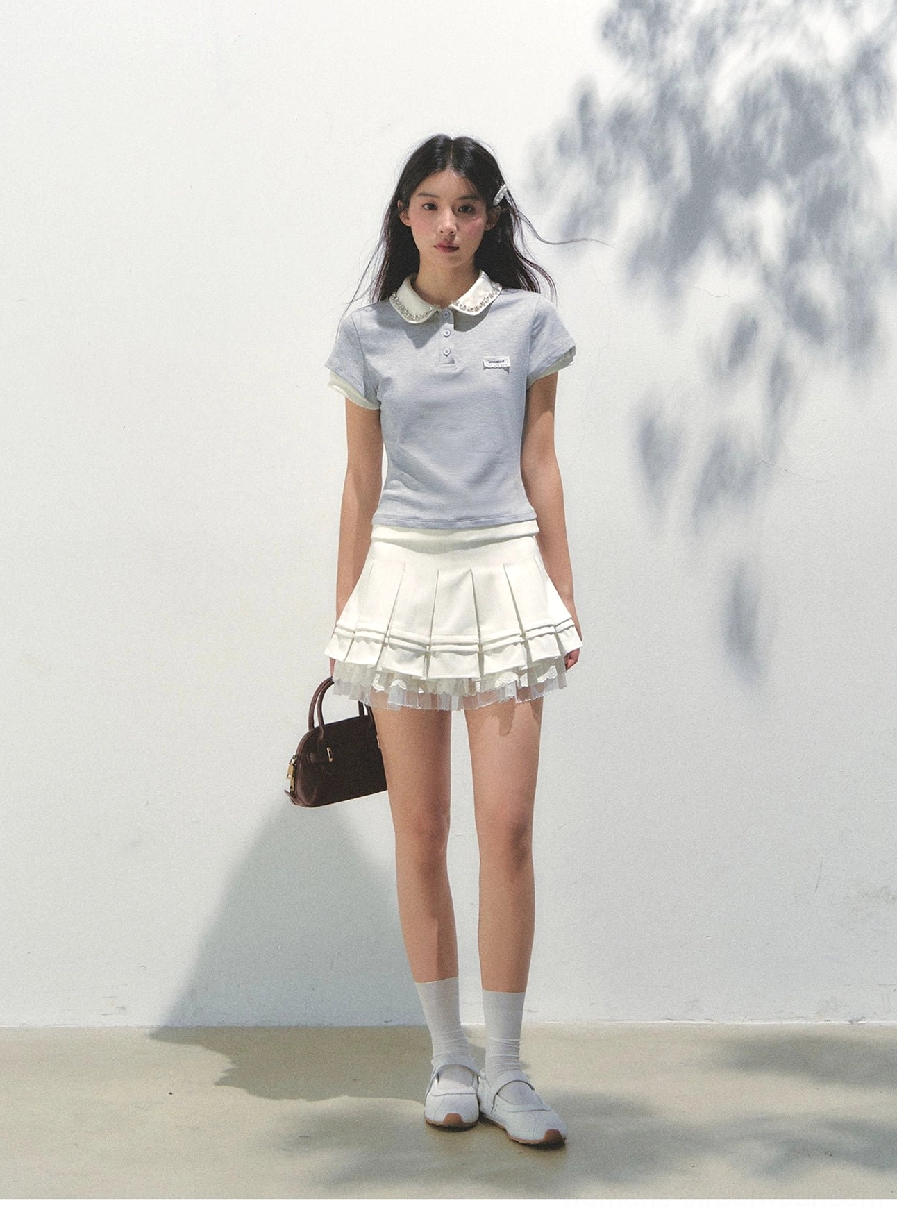 Glass blue fitted lace collar cotton polo shirt styled with white ruffled mini skirt loafers and socks