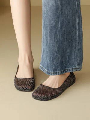 Model wearing dark glitter mesh jelly ballet flats with blue wide-leg jeans in a casual streetwear outfit