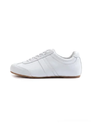 All-white gloss-finish leather low-profile retro trainers with lace-up front, subtle side stripe, and gum rubber outsole on a clean studio background