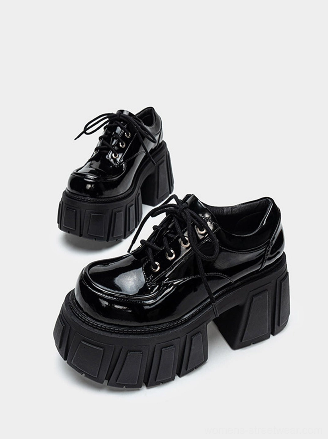 Glossy black chunky platform derby shoes featuring exaggerated split platform, block heel, and Oxford-inspired silhouette