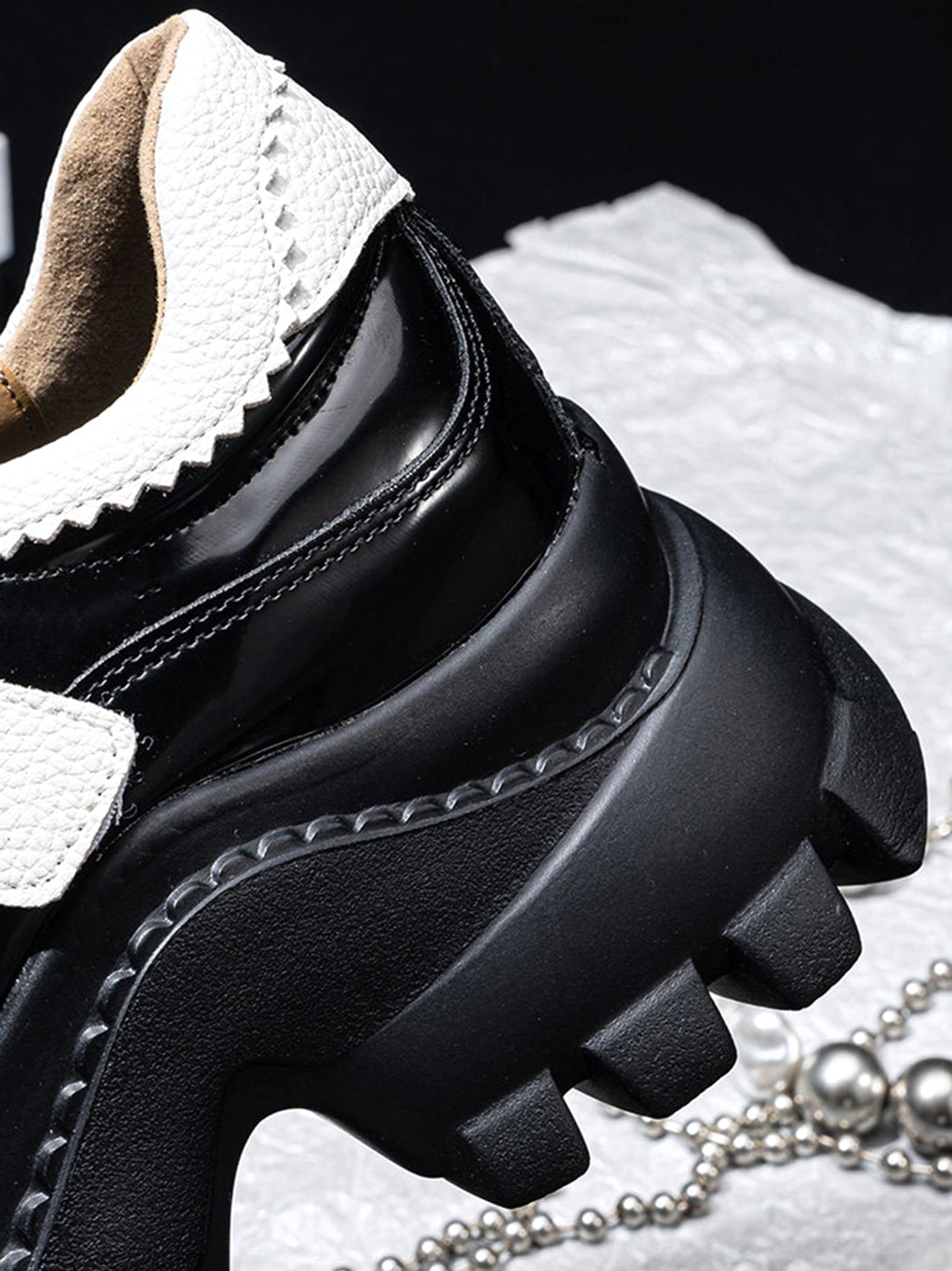 Glossy black and white chunky platform Mary Jane shoes with adjustable straps and a bold monochrome streetwear aesthetic