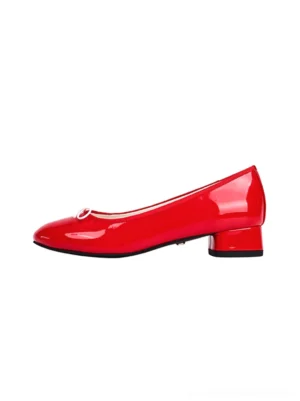 Red glossy low-heel ballet pumps with rounded toe, white bow detail, and short block heel on a white studio background