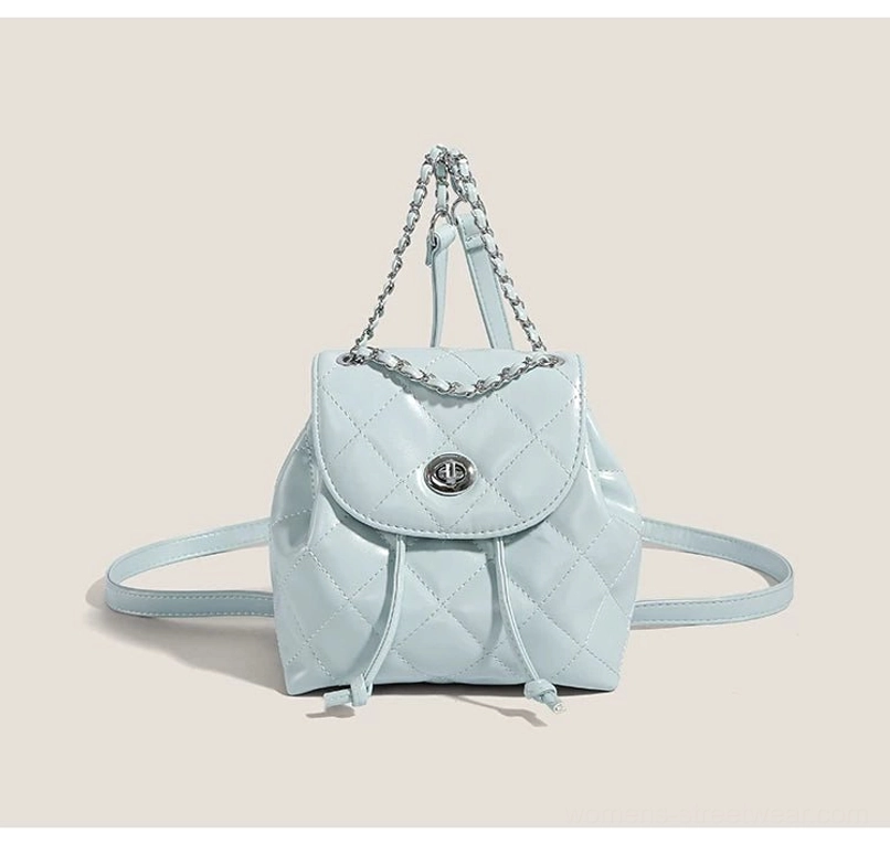 Sky blue glossy quilted mini backpack with silver twist lock and chain handle front view