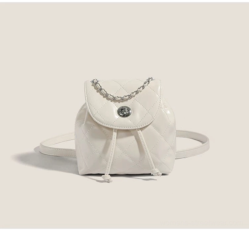 White glossy quilted mini backpack with chain detail and adjustable straps