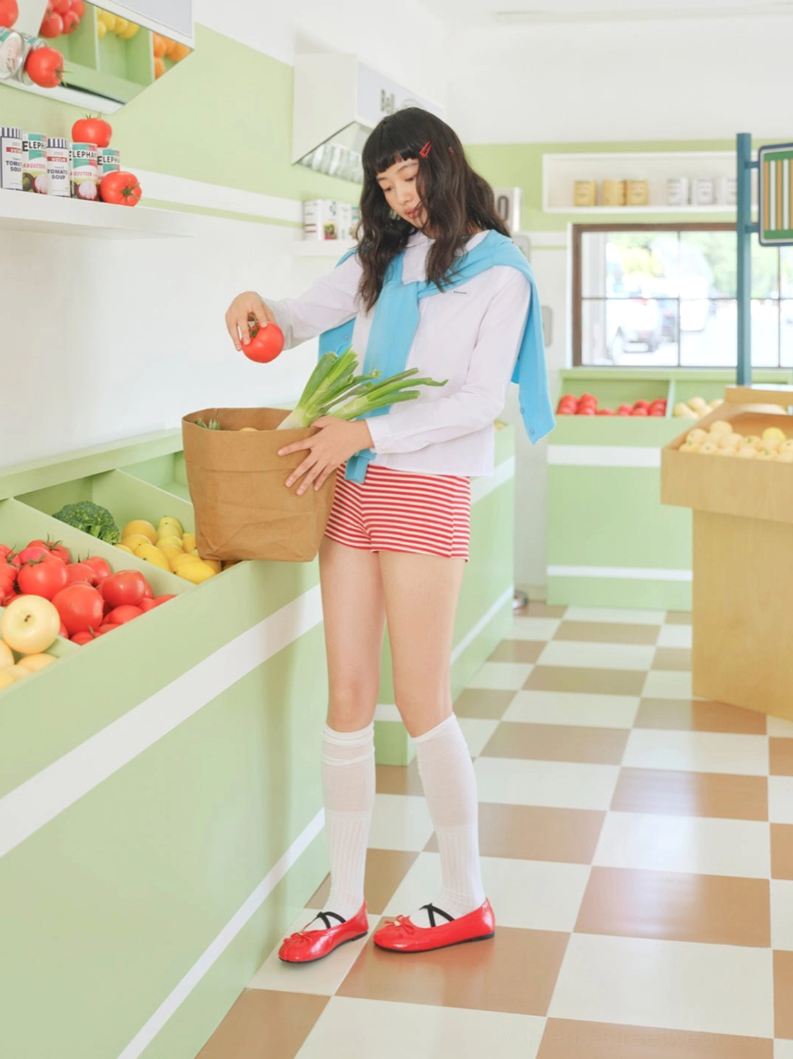 Full outfit view featuring glossy red split-toe Mary Jane ballet flats with bow detail in retro market setting