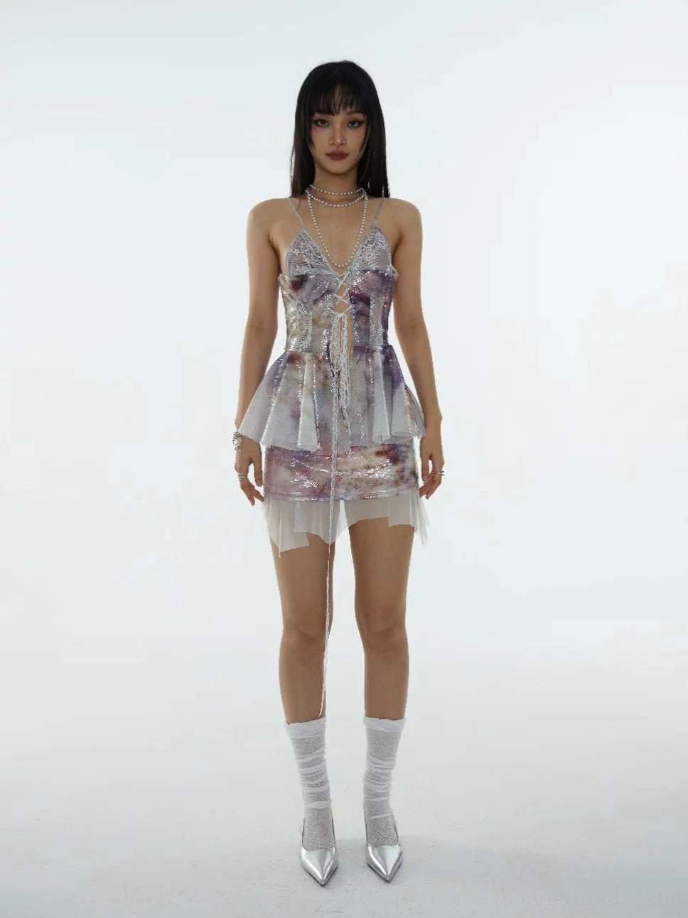 Front view of a glossy tie-dye sequin layered mini skirt with fluttering white chiffon godets and an iridescent Y2K streetwear finish