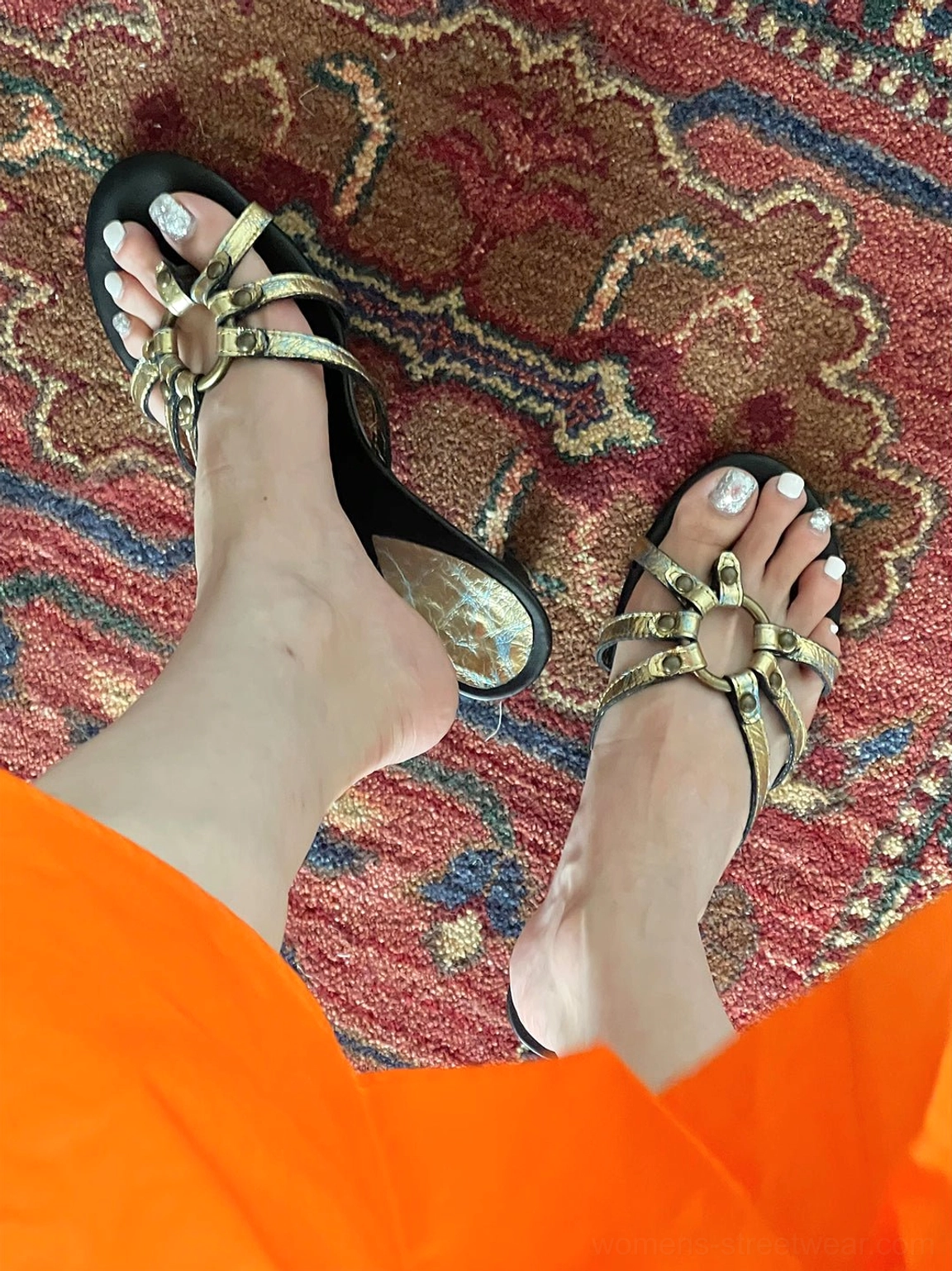 Overhead fashion view of gold crackle-metal thong sandals with decorative circular toe hardware and contrasting black soles