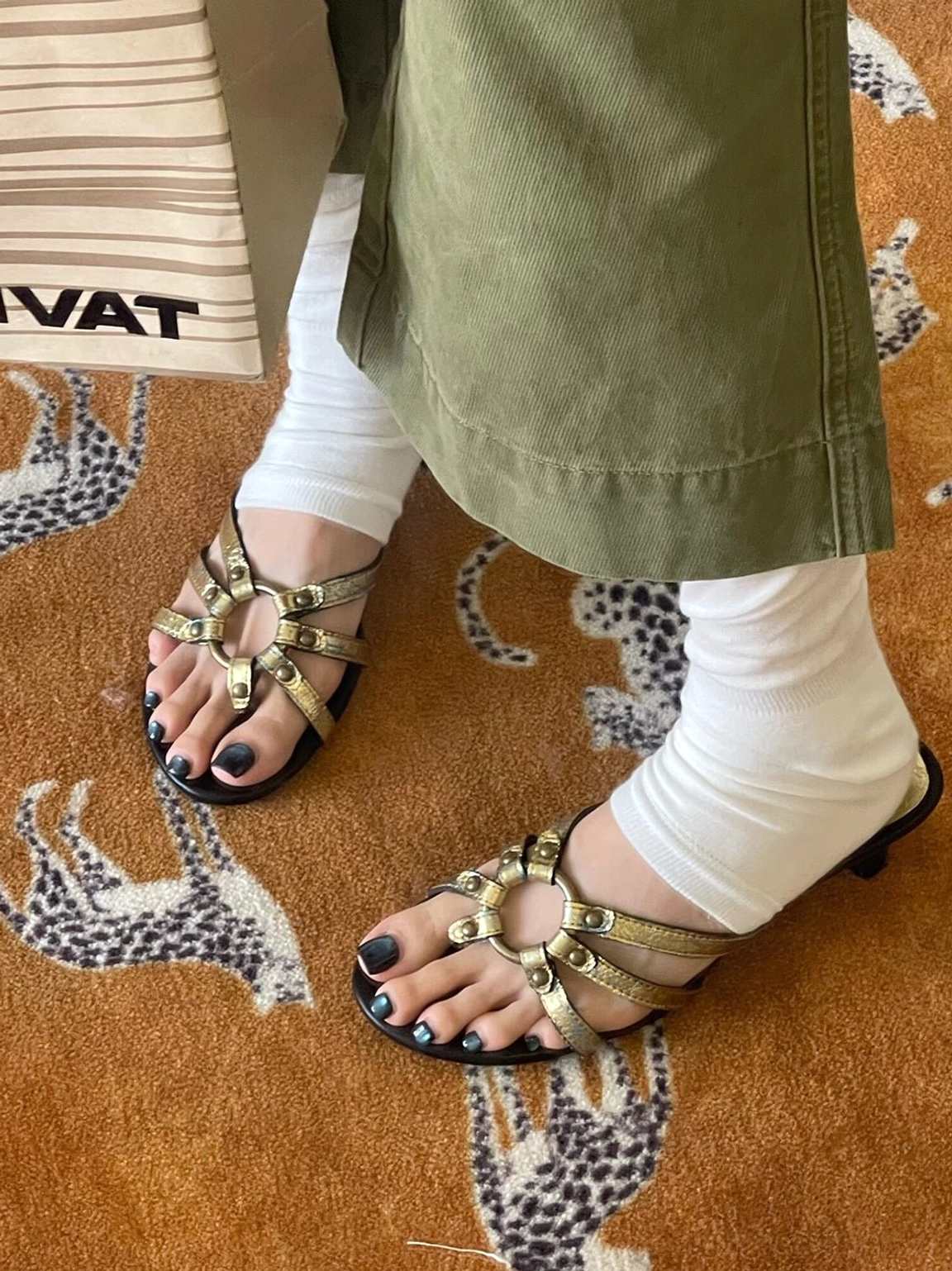 Top view of a pair of gold crackle metallic sandals with secure grommet strap details and slim sculpted kitten heels