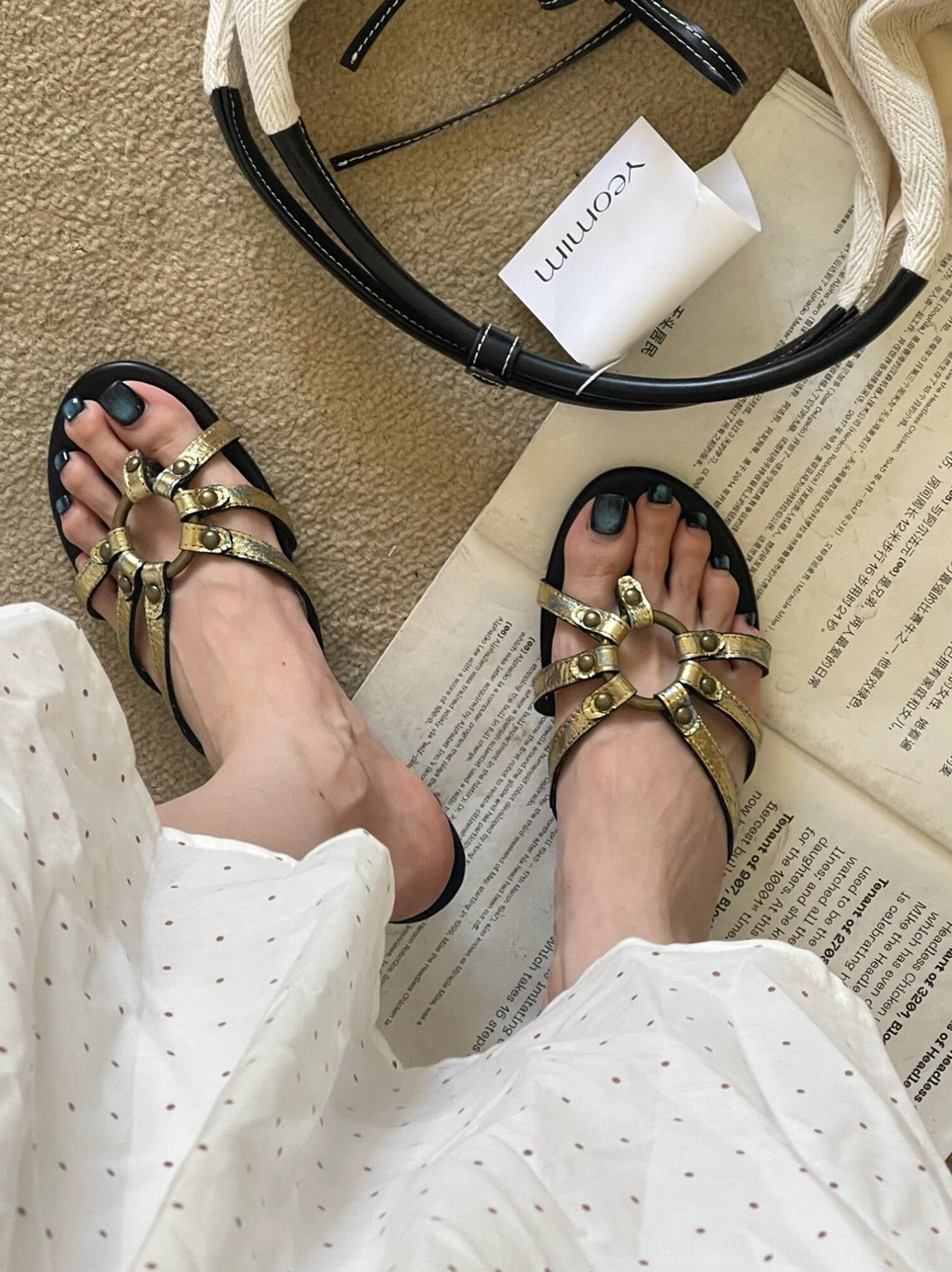 Overhead view of gold open-toe thong sandals displaying full strap construction, metallic crackle texture, and low kitten heels