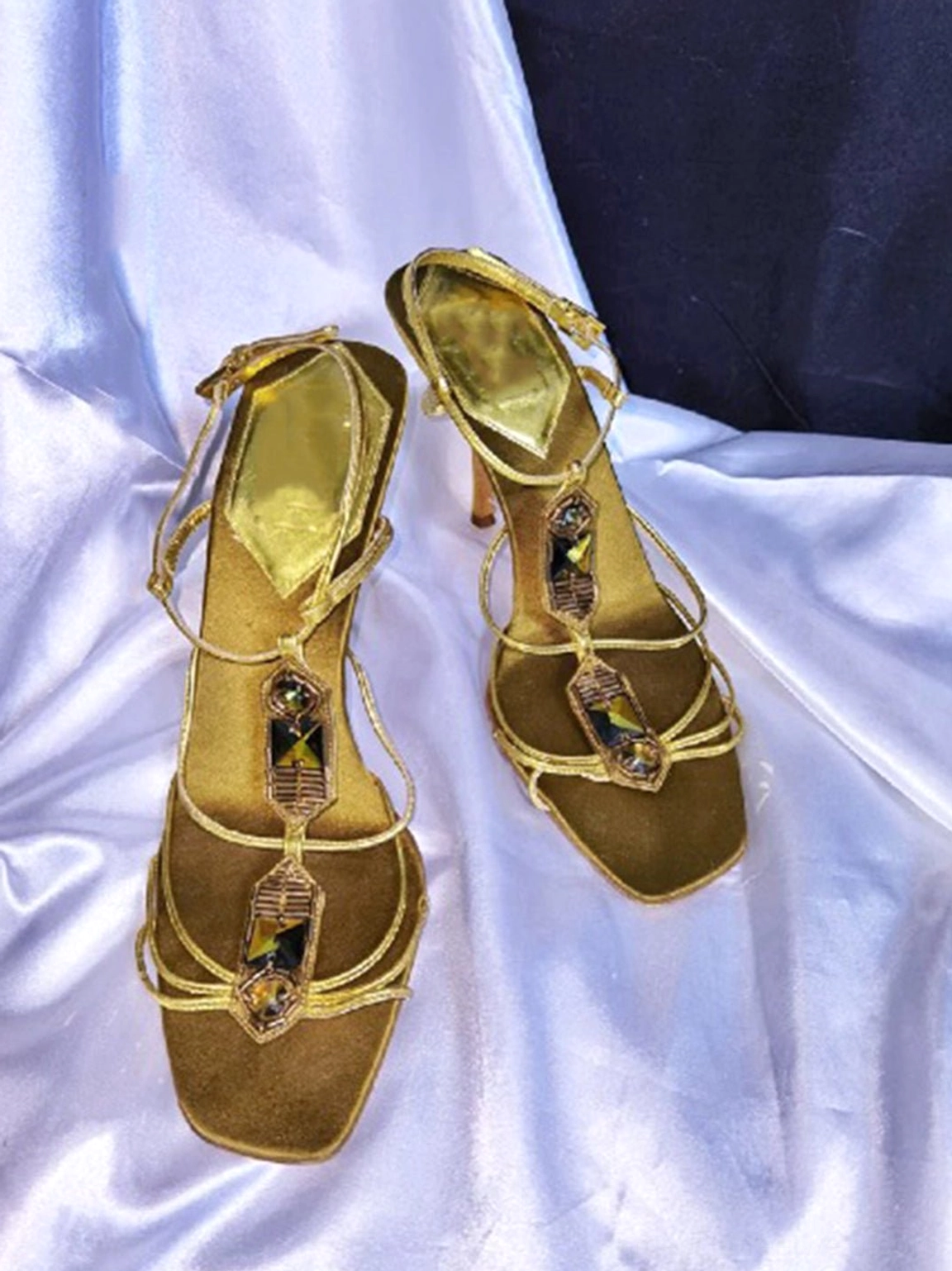 Gold rhinestone lace-up square-toe sandals displayed in a top-down flat lay with jeweled straps and delicate ankle ties