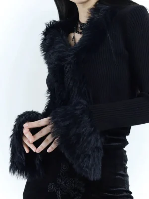 Close-up of black gothic ribbed knit cropped cardigan showing plush faux fur V-neck trim and fluffy cuff detail