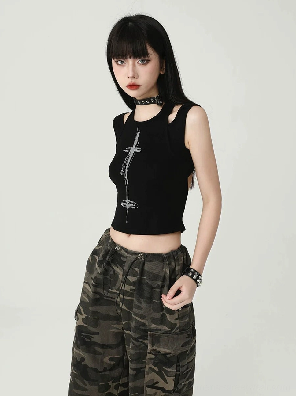 Women's black gothic cross cropped tank top in a side front view with fitted ribbed texture, silver cross print, and Seoul streetwear styling