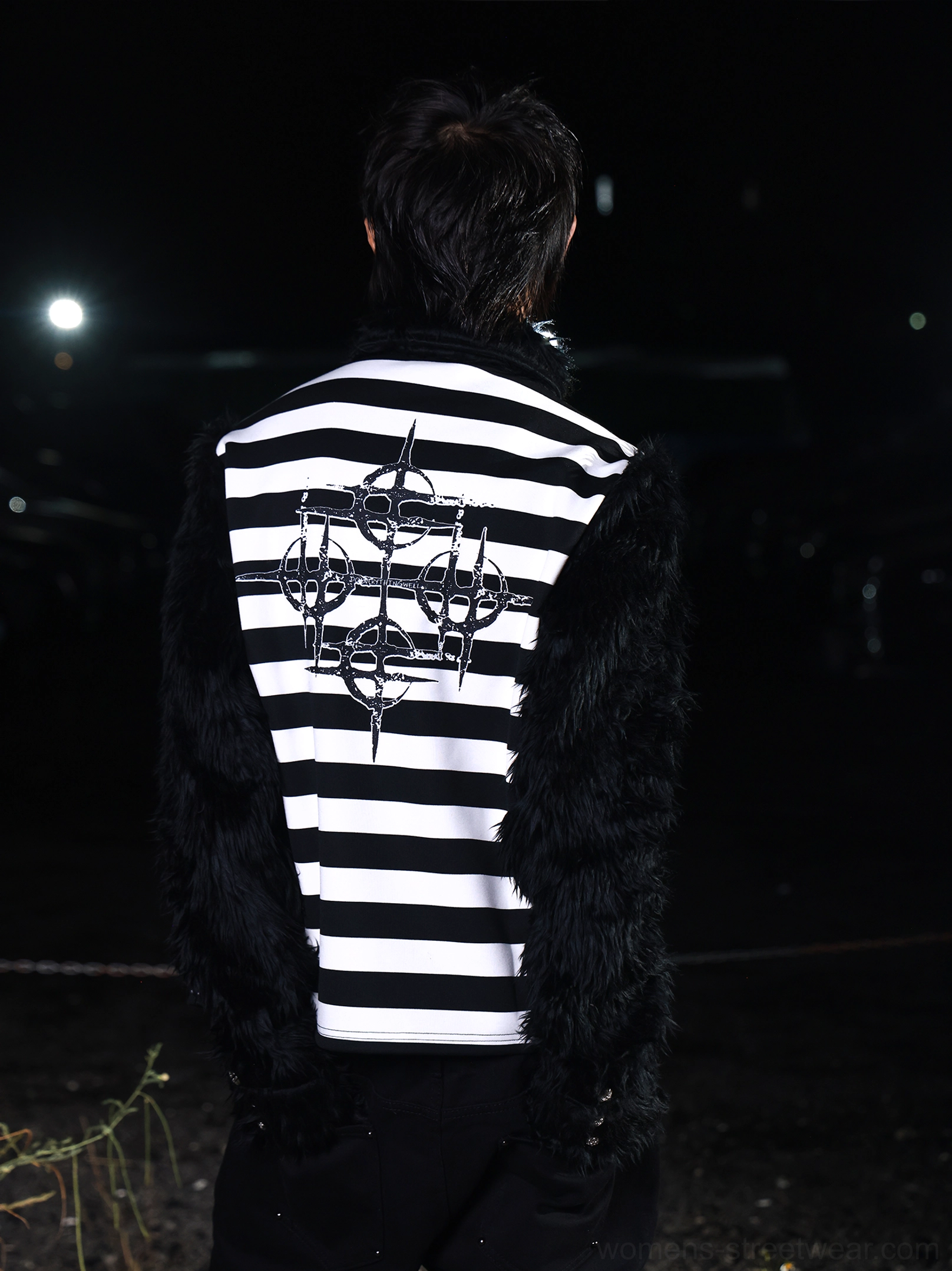 Back view of black and white faux fur striped streetwear shirt featuring large gothic sigil embroidery across the back and textured black sleeves