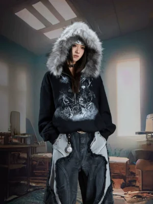 Black gothic faux fur trim graphic zip hoodie styled with patchwork cargo denim in a dim vintage room