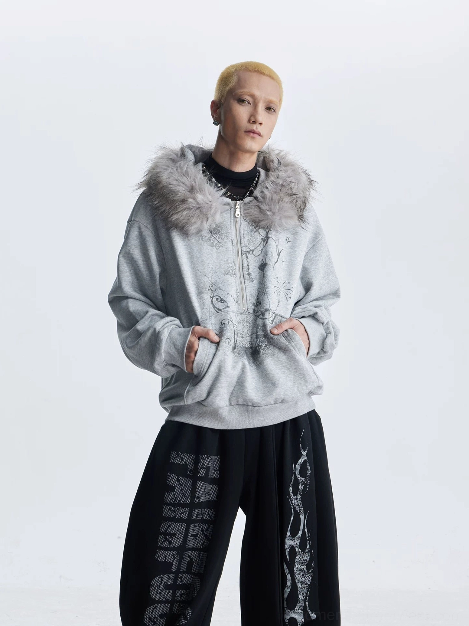 Gray gothic faux fur trim graphic zip hoodie front view styled with flame pattern wide leg trousers