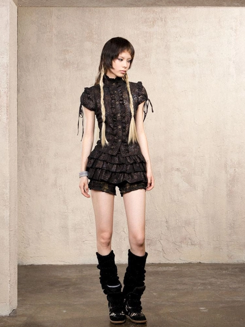 Gothic lace-up top styled with layered lace ruffle skort pants and platform ankle boots for streetwear