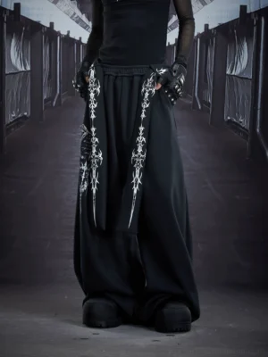 Black gothic sigil drape streetwear cargo sweatpants front view featuring ultra-wide legs, distressed leg graphic, and cross hanging straps