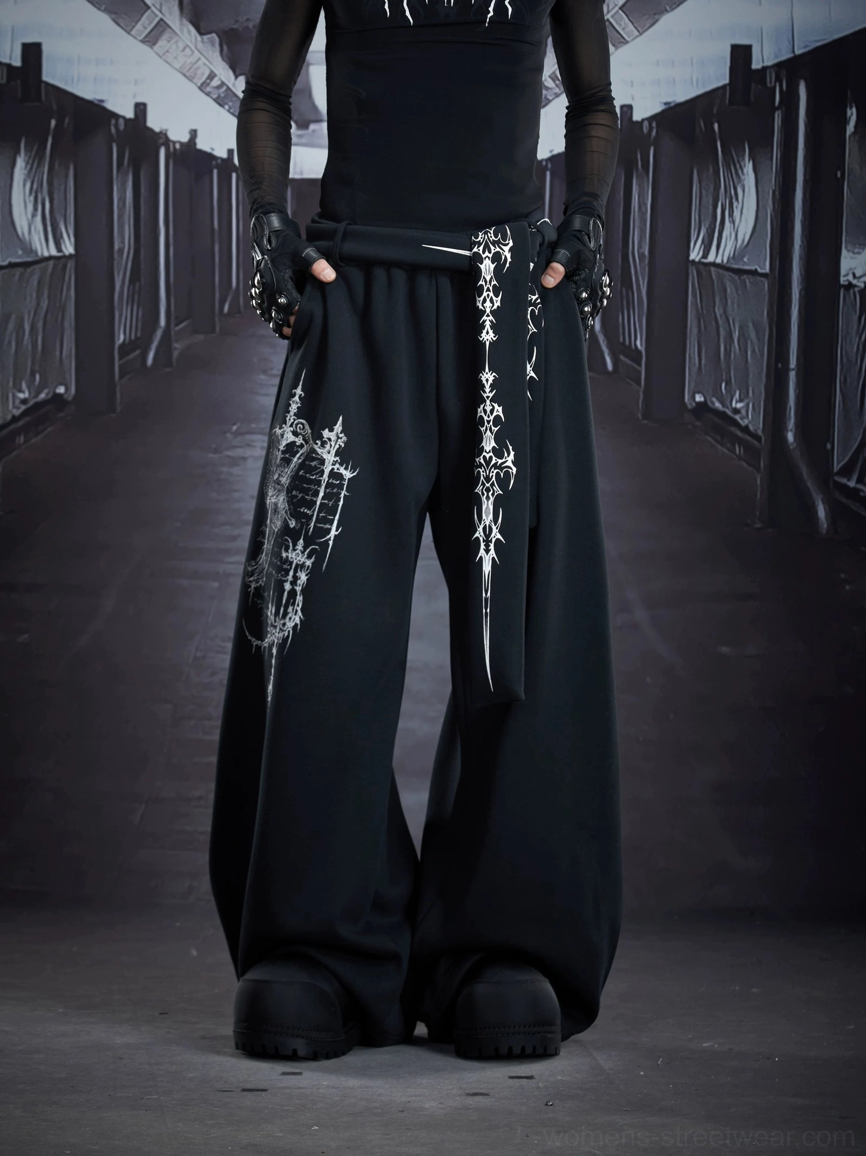 Black oversized gothic sigil drape streetwear cargo sweatpants three quarter front view with cross hanging decorations