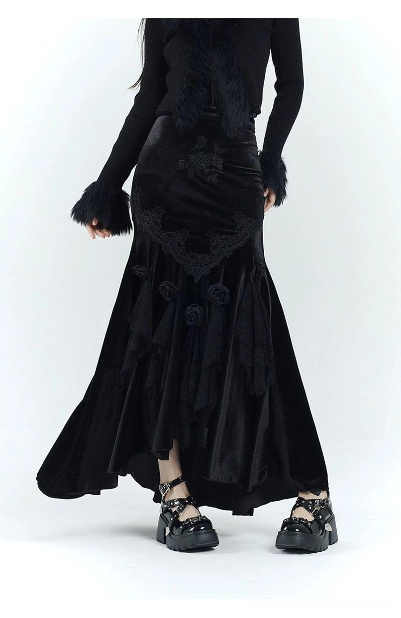 Three-quarter side view of a gothic velvet fishtail dress with flowing asymmetric hem, three-dimensional roses, lace details, and chunky platform shoes