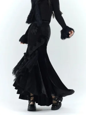 Black gothic velvet fishtail dress detail with lace ruffles, faux fur cuffs, and dramatic asymmetric hem in a studio setting