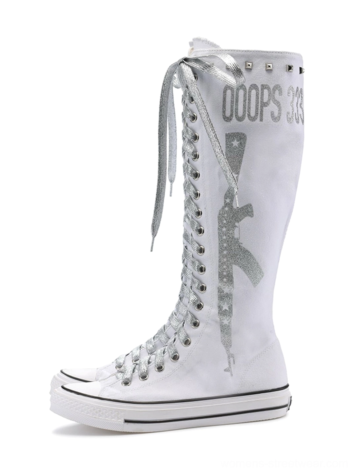 Graphic canvas knee-high streetwear boots with metallic studs, full-length lacing, side zipper, white rubber toe caps, and punk styling