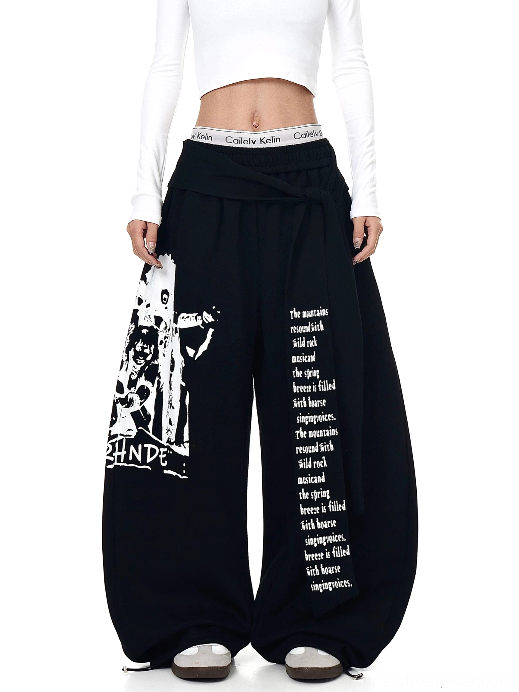 Black oversized graphic fleece streetwear pants with ultra wide legs and retro figure print front studio view