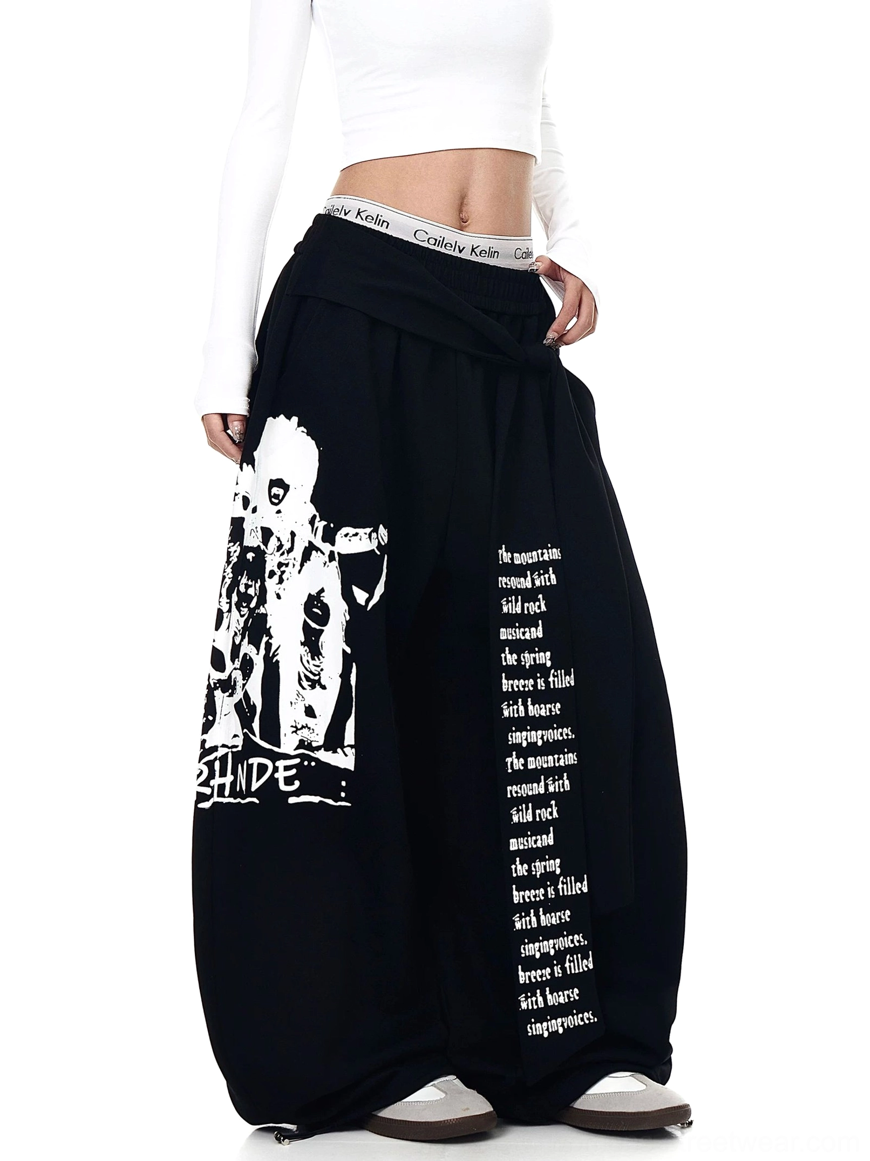 Black graphic ultra wide leg streetwear sweatpants with retro figure artwork shown in three quarter front view