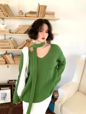 Grass green ribbed V-neck sweater with matching skinny scarf tie worn by model in a vintage home study