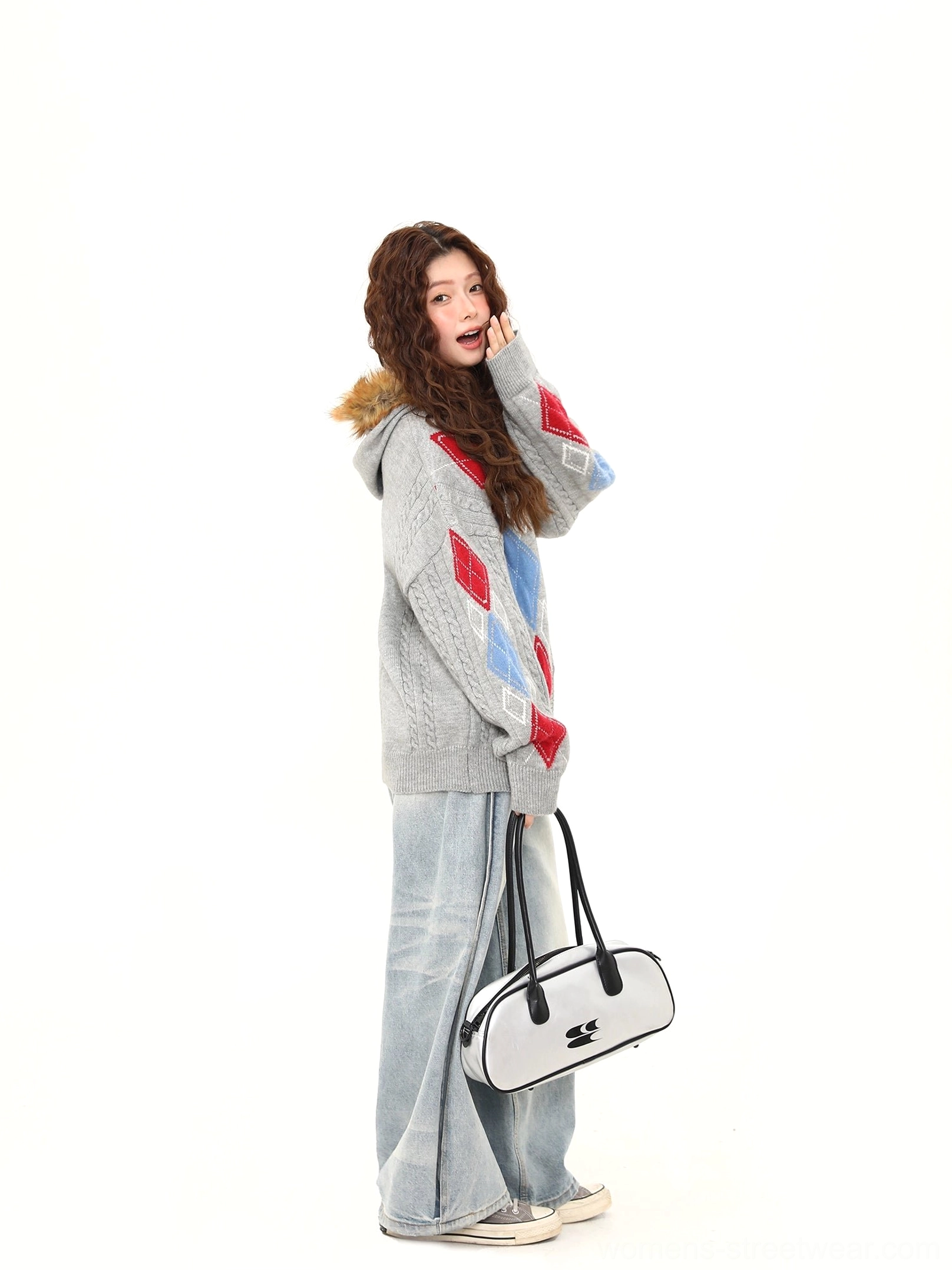 Gray argyle cable knit oversized button cardigan side profile with wide leg denim and mini handbag