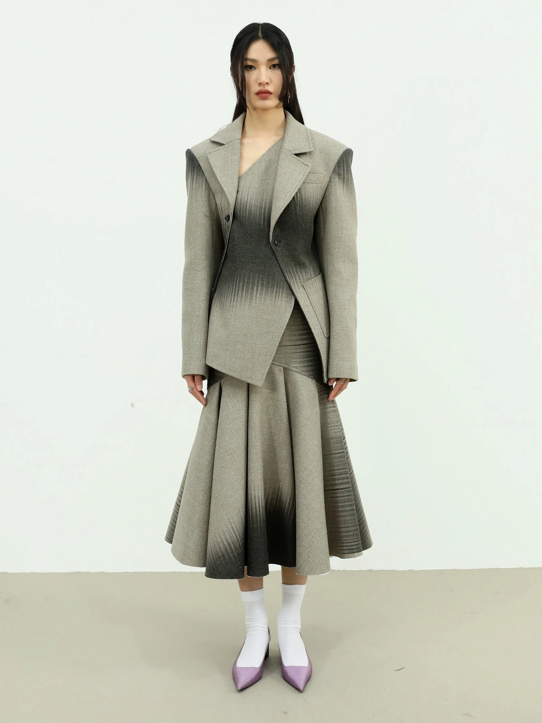 Full-length gray to black ombre fishtail maxi skirt shown with a structured matching blazer in a minimalist formal streetwear look