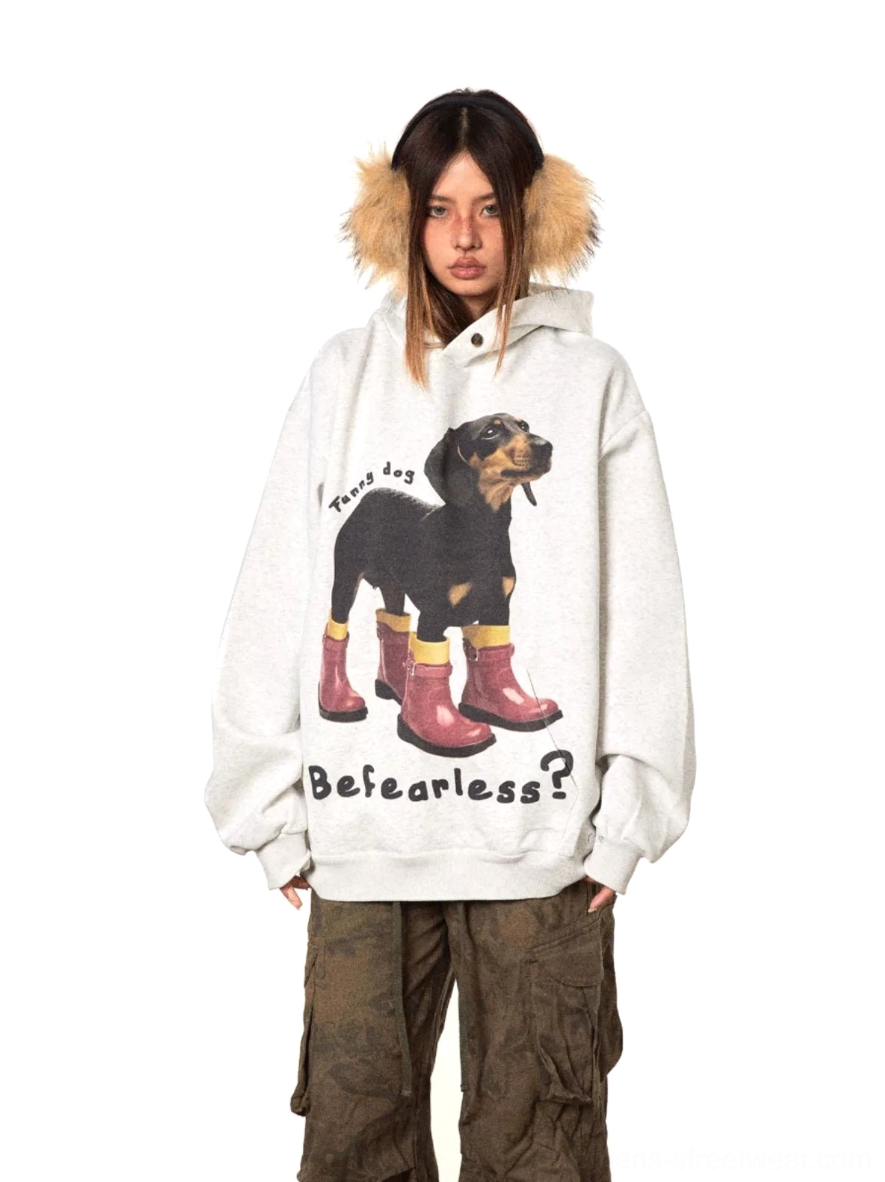 Gray oversized dog graphic hoodie with dachshund wearing red rain boots, fearless slogan, and soft hood trim shown in a front three-quarter streetwear outfit