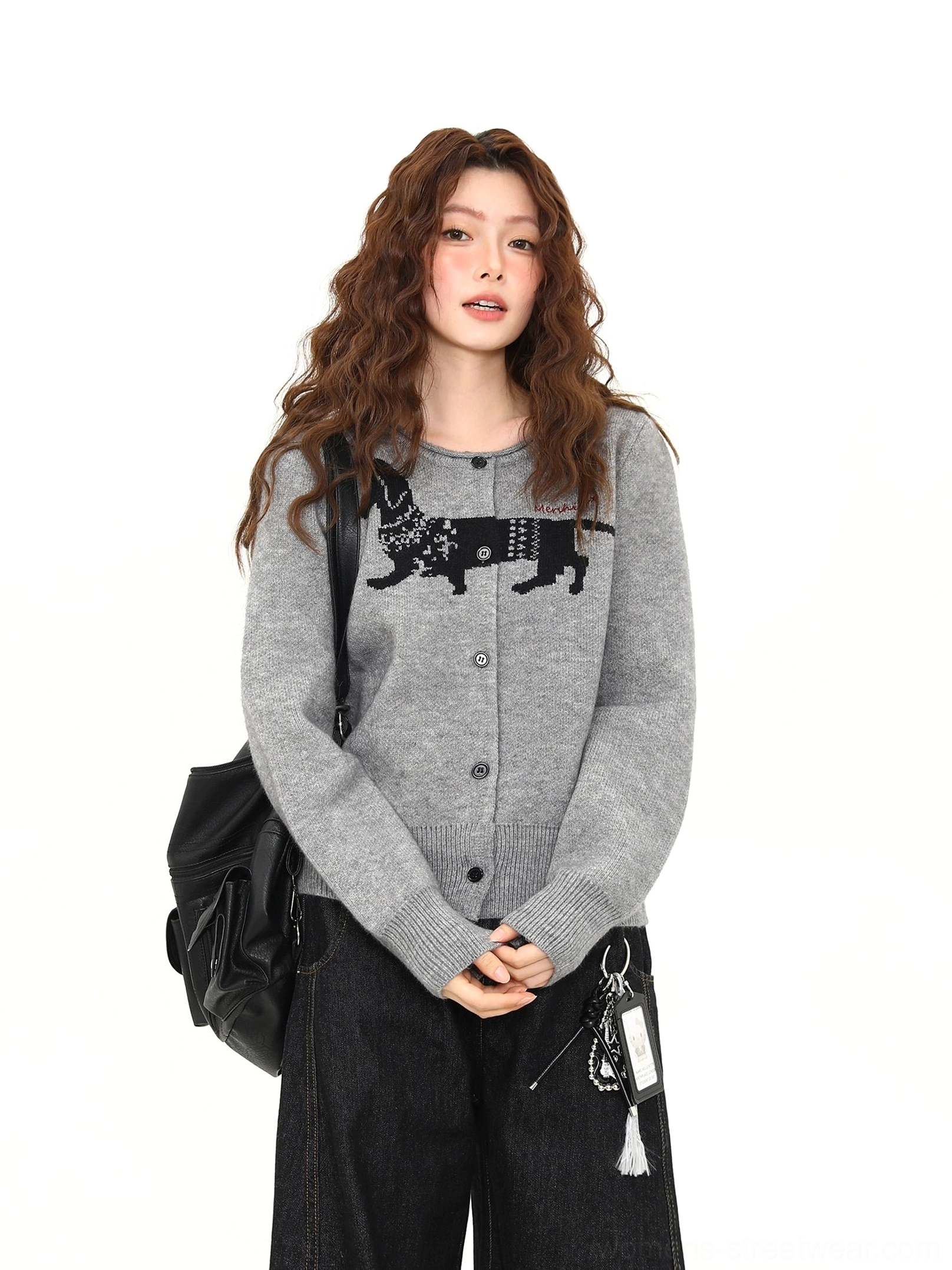 Three-quarter front view of a gray button-front dachshund knit cardigan with oversized black jacquard chest graphic and soft textured fabric