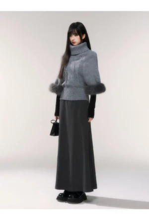 Side view of gray turtleneck cable knit sweater with plush faux fur cuffs and ribbed cropped hem