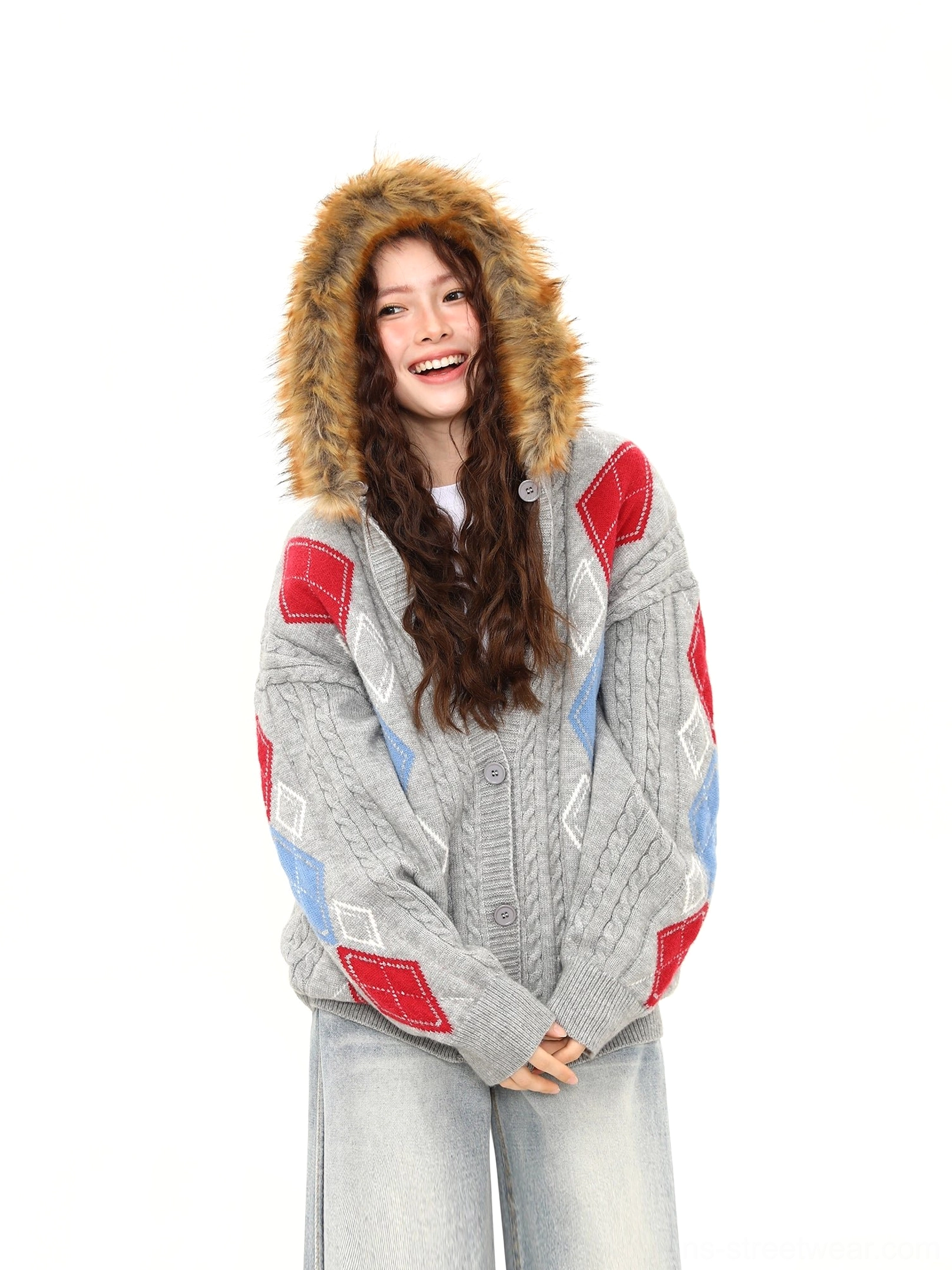 Side view of gray faux fur hood argyle cable knit oversized cardigan showing ribbed cuffs and relaxed sleeves