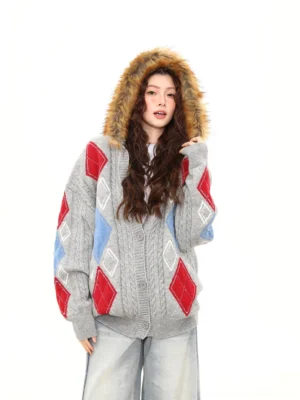 Gray faux fur hood argyle cable knit oversized cardigan front three quarter view with light blue wide leg jeans