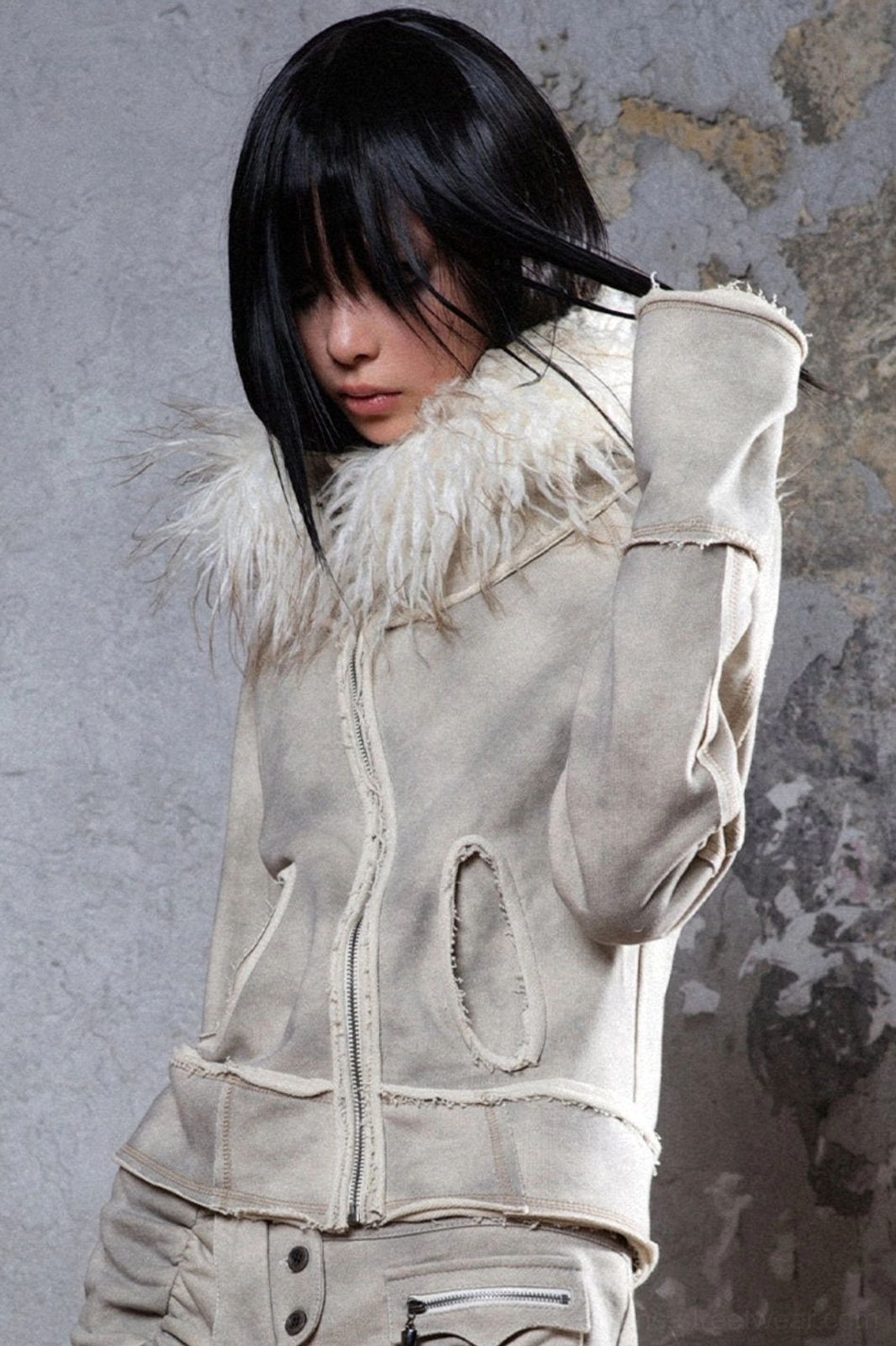 Back three-quarter view of a gray faux fur hooded streetwear jacket with raw seam accents and relaxed winter styling