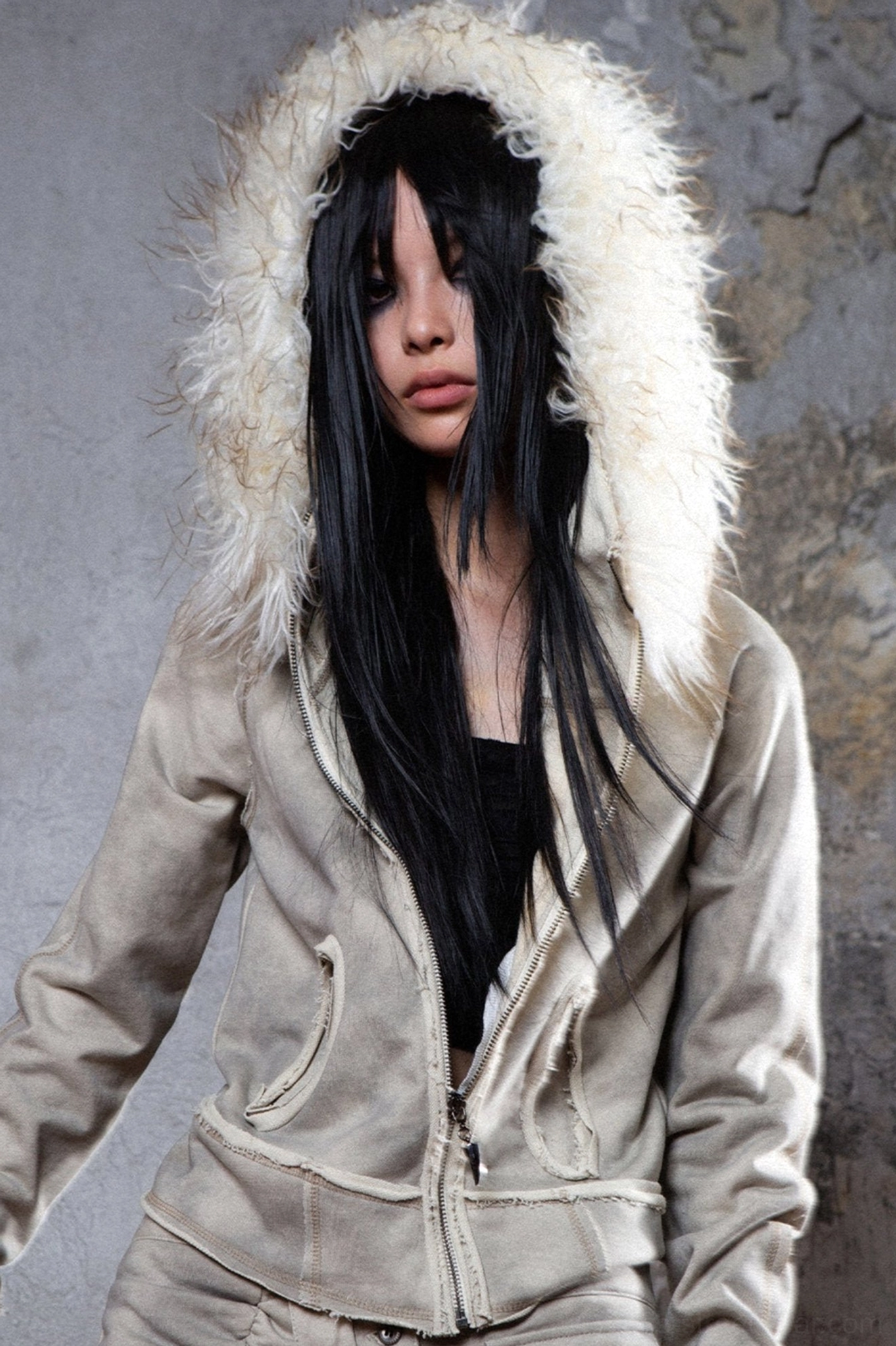 Gray faux fur hooded jacket front view with fluffy off-white trim, relaxed streetwear fit, raw seam details, and front patch pockets