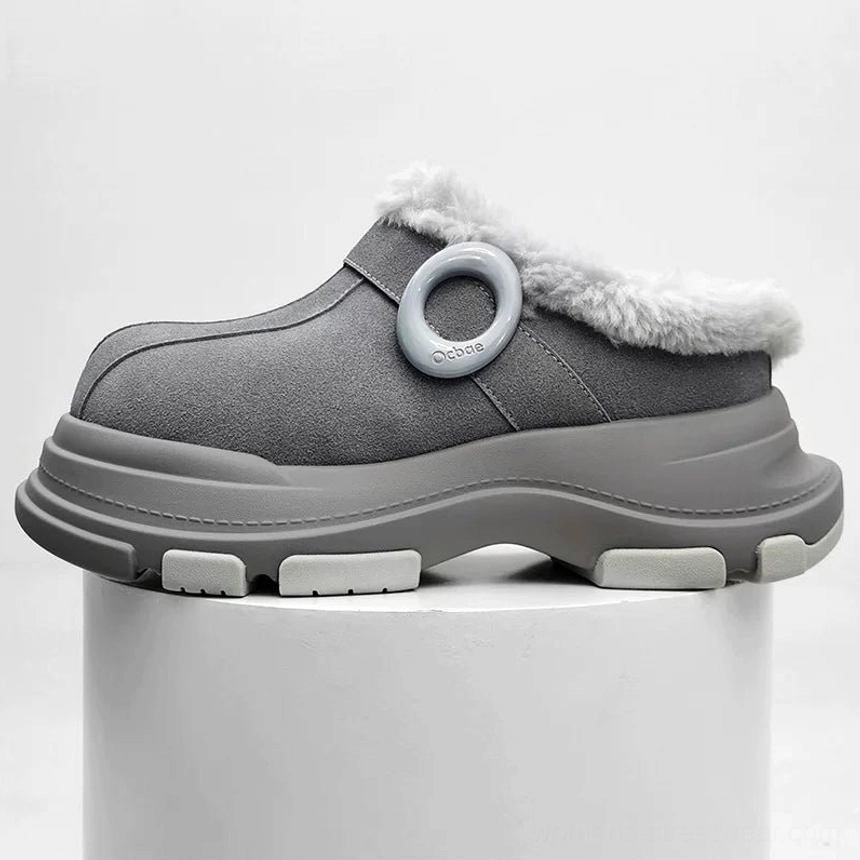 Gray fleece-lined chunky platform clog on a white display plinth with circular ring accent, soft suede-finish upper, and light anti-slip outsole blocks