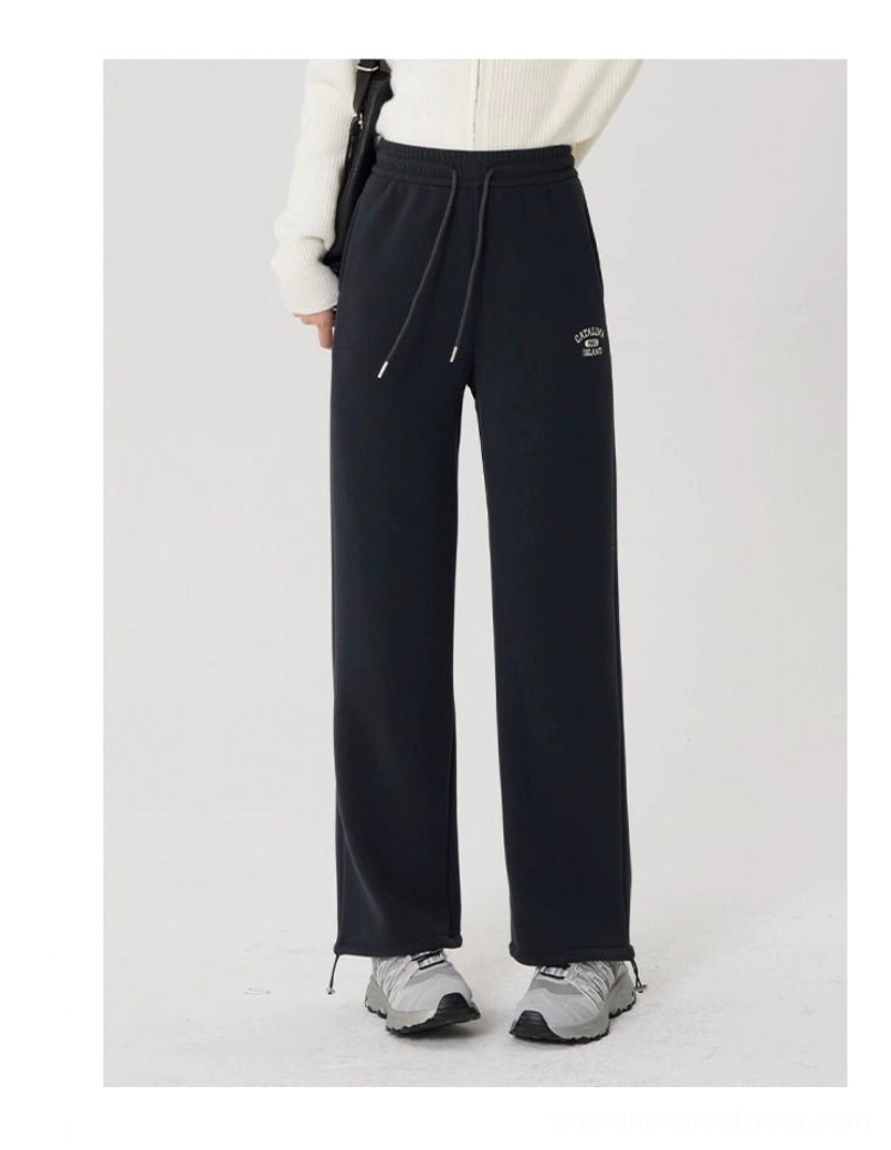Full-body front view of gray fleece-lined straight-leg streetwear pants with adjustable hem drawstrings, white top, and casual sneakers