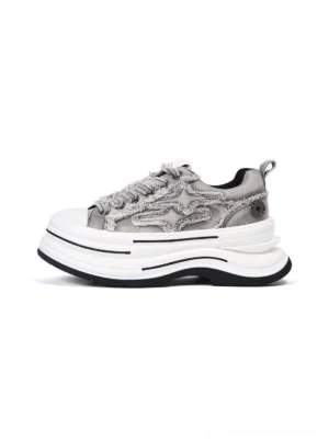 Gray frayed canvas 7 cm platform sneakers shown from an oblique front top view with raw-edge overlays, layered sole, and white round toe cap